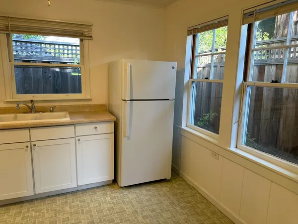 a white refrigerator freezer sitting in a kitchen