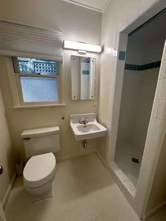 a bathroom with a toilet a sink and a mirror