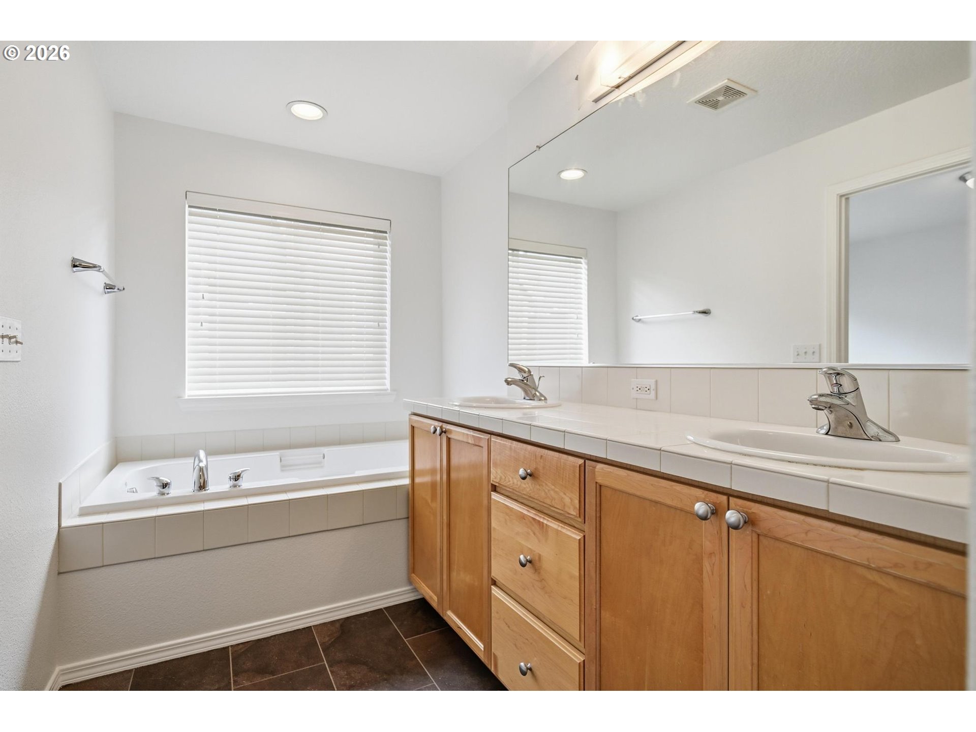 1638 Southwest 173rd Terrace Beaverton, OR 97003 - Photo 22 of 41 a bathroom with a sink double vanity and a bathtub