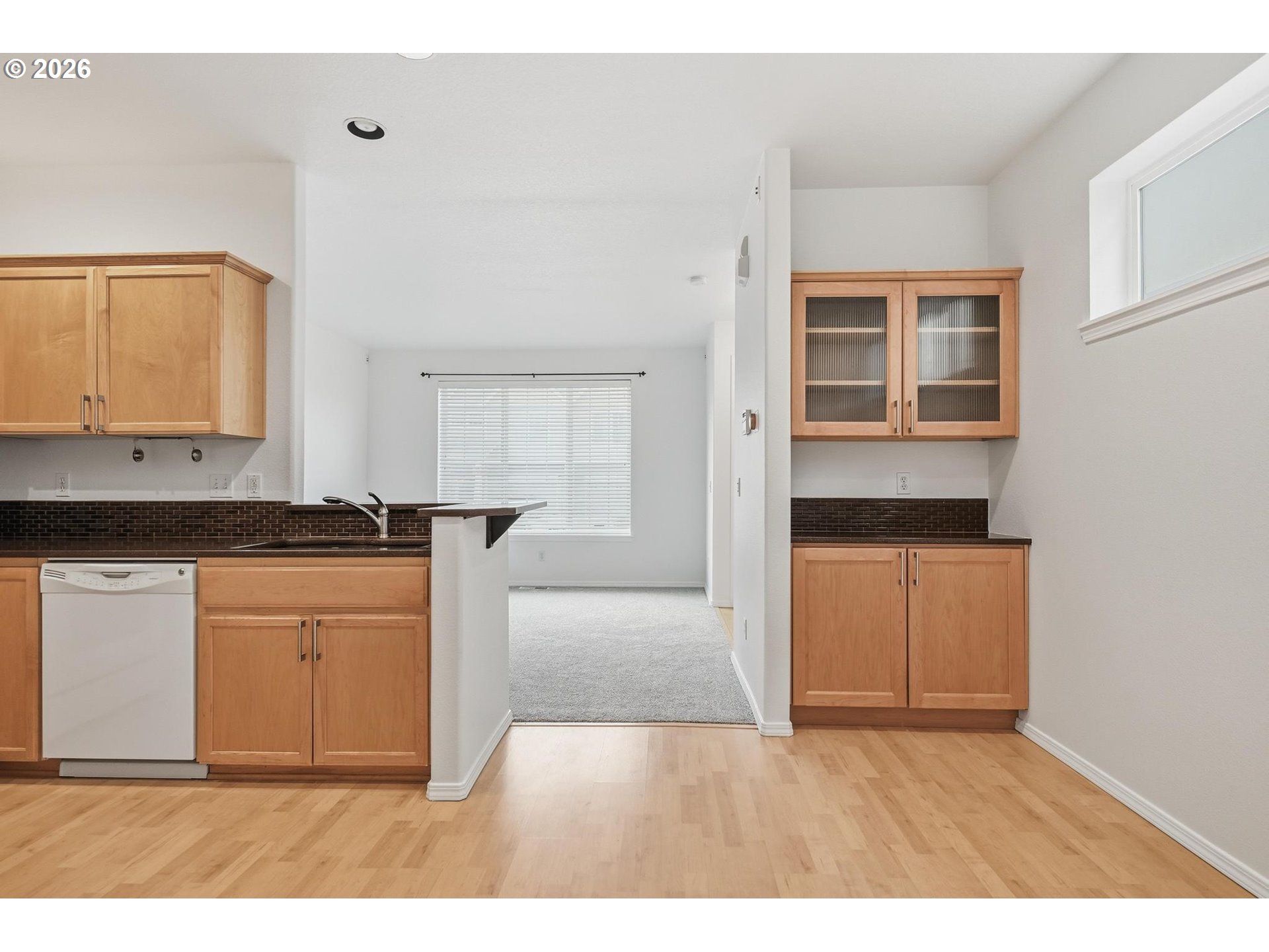 1638 Southwest 173rd Terrace Beaverton, OR 97003 - Photo 7 of 41 a kitchen view with granite countertop a stove a sink and a refrigerator with wooden floor