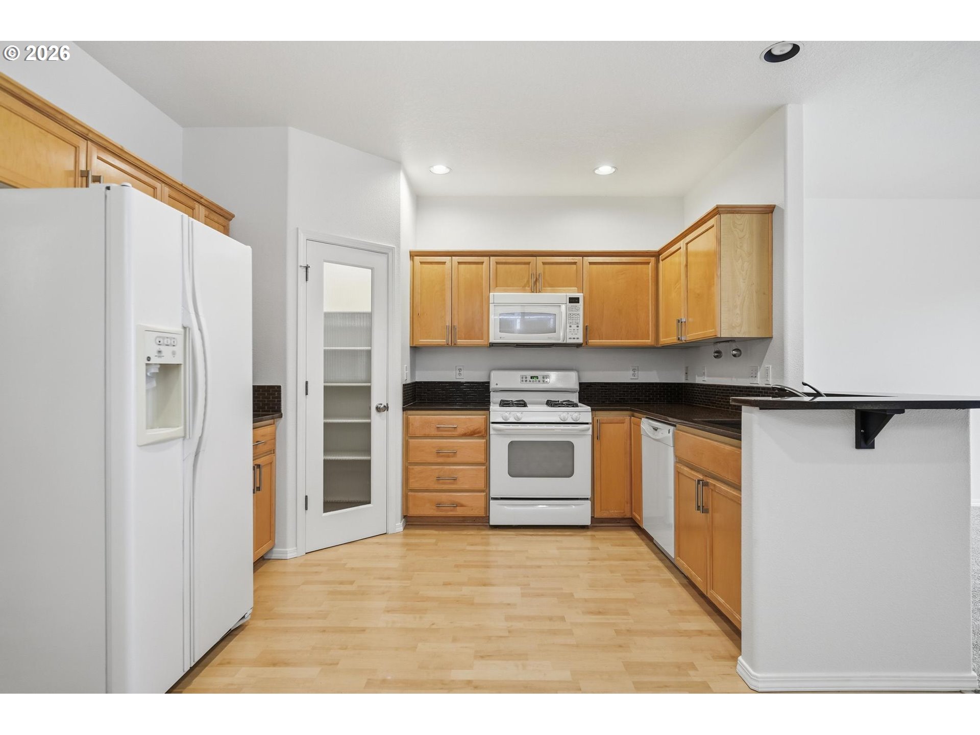 1638 Southwest 173rd Terrace Beaverton, OR 97003 - Photo 10 of 41 a kitchen with stainless steel appliances granite countertop a refrigerator and a stove top oven