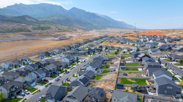 1692 South Windemere Road Santaquin, UT 84655 - Photo 23 of 23 Expansive neighborhood featuring numerous detached homes with gray and light-colored exteriors, asphalt shingle roofs, and some properties with visible solar panels