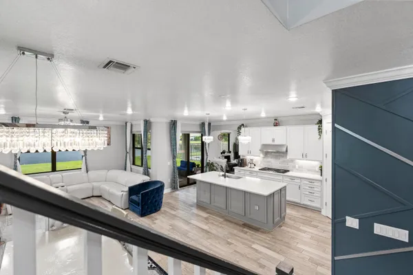 a large kitchen with kitchen island a large counter space a dining table and chairs
