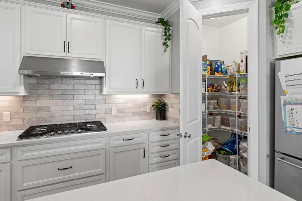a living room with furniture and kitchen view