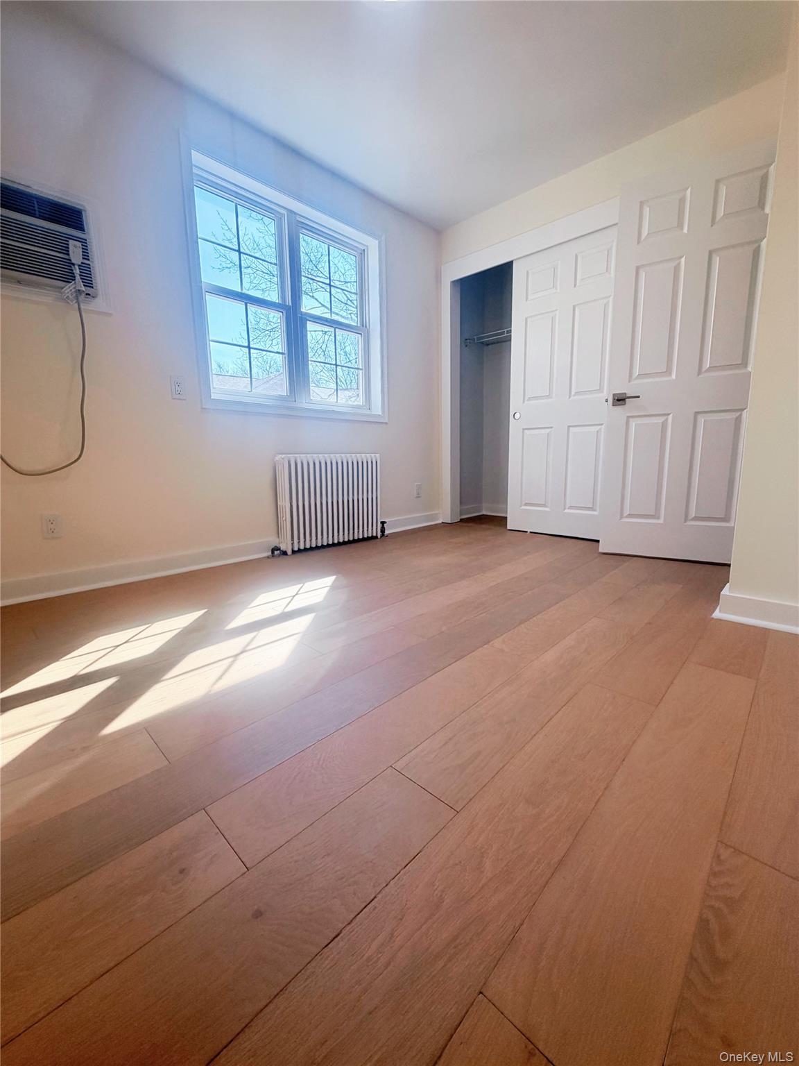 64-11 Springfield Boulevard, Unit B Queens, NY 11364 - Photo 5 of 11 a view of an empty room with a window