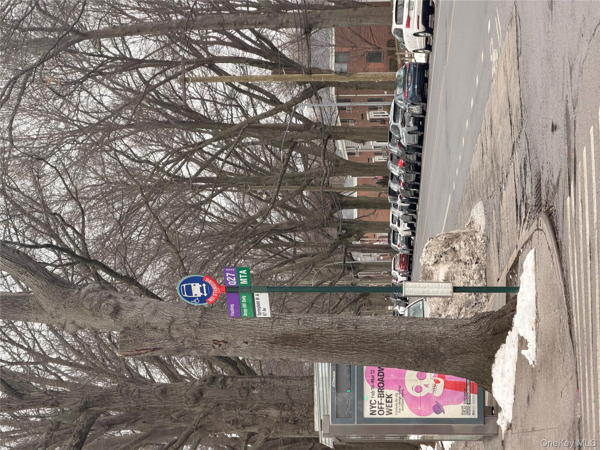 64-11 Springfield Boulevard, Unit B Queens, NY 11364 - Photo 10 of 11 a street sign on a sidewalk next to a road