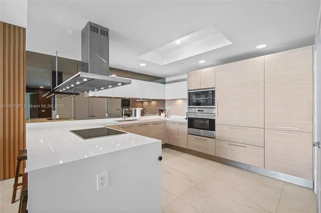a kitchen with stainless steel appliances kitchen island granite countertop a stove and a refrigerator