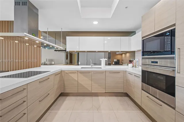 a kitchen with white cabinets and appliances