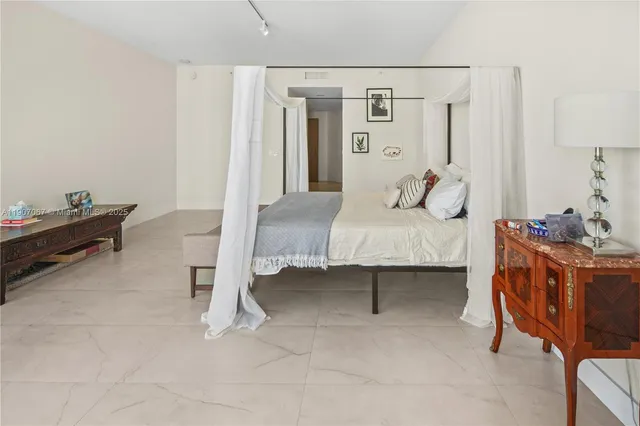 a bedroom with a bed and a table in it