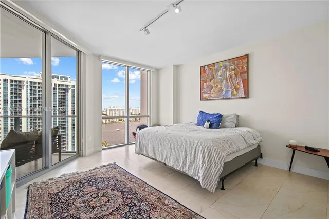 a bedroom with a bed and glass window
