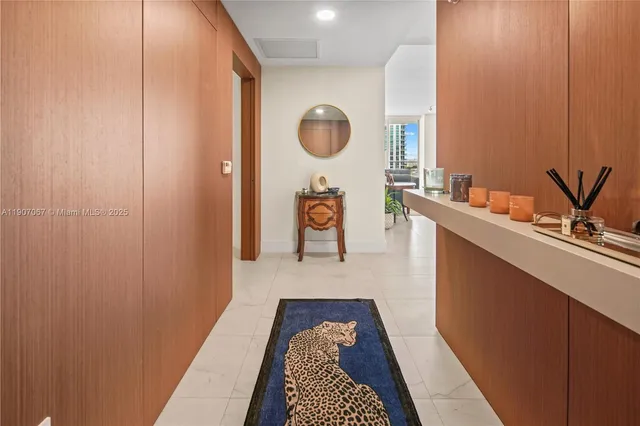 a hallway with a large mirror and a sink