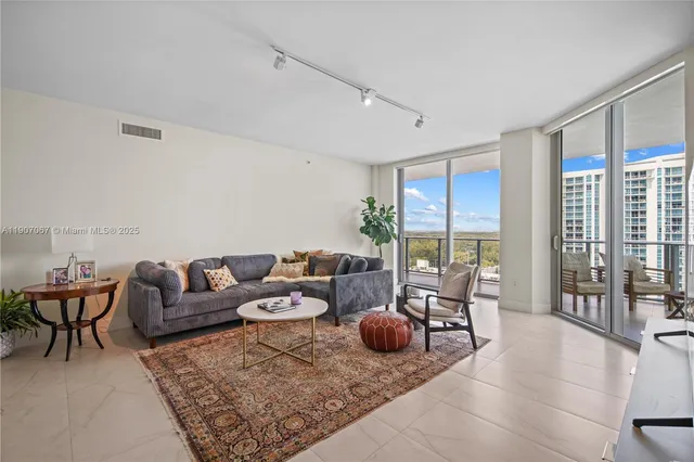 a living room with furniture and large windows