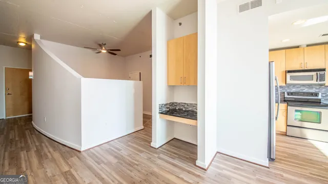 a kitchen with a refrigerator and a stove top oven