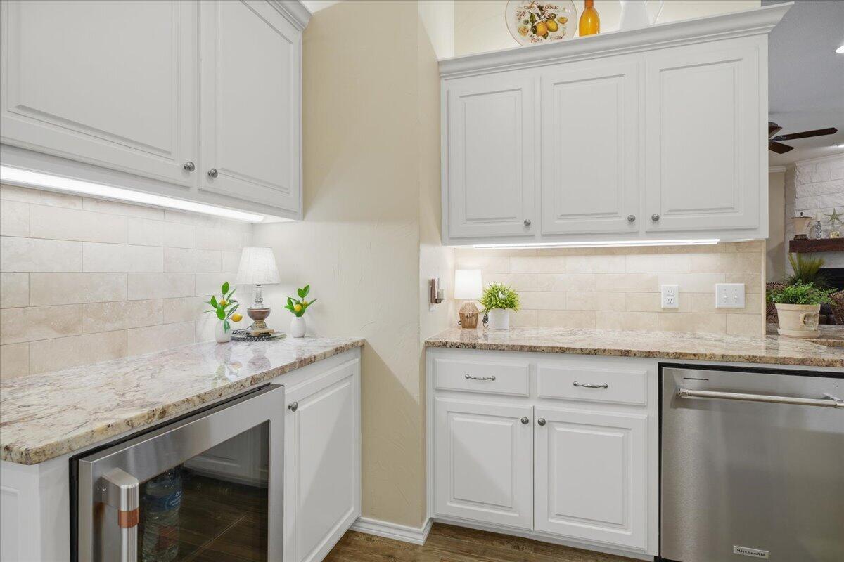 4612 100th Street Lubbock, TX 79424 - Photo 21 of 55 a kitchen with granite countertop white cabinets and white appliances
