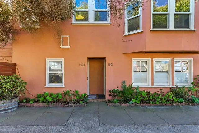 a living room with furniture a flat screen tv and a window