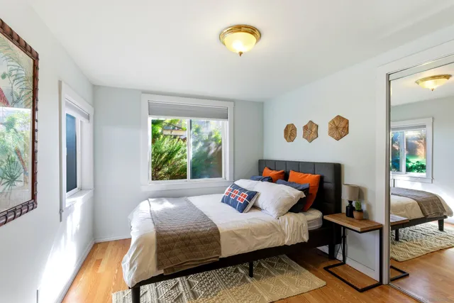 a bedroom with furniture and a wooden floor
