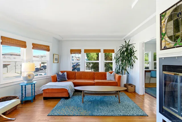 a living room with furniture a rug and a large window