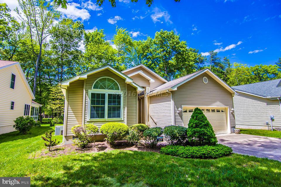 217 Windjammer Road Ocean Pines, MD 21811 - Photo 1 of 47 a front view of house with yard and green space