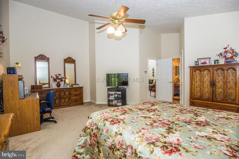 217 Windjammer Road Ocean Pines, MD 21811 - Photo 19 of 47 a bed room with a bed and a chandelier
