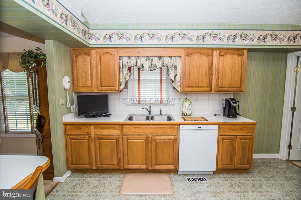 217 Windjammer Road Ocean Pines, MD 21811 - Photo 23 of 47 a kitchen with a stove a sink and a refrigerator