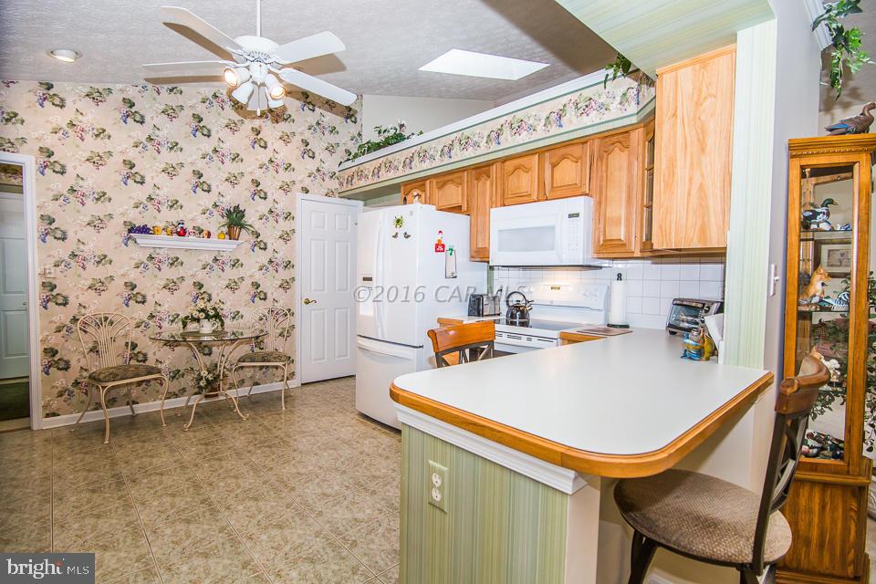 217 Windjammer Road Ocean Pines, MD 21811 - Photo 25 of 47 a kitchen with a sink a stove and a refrigerator