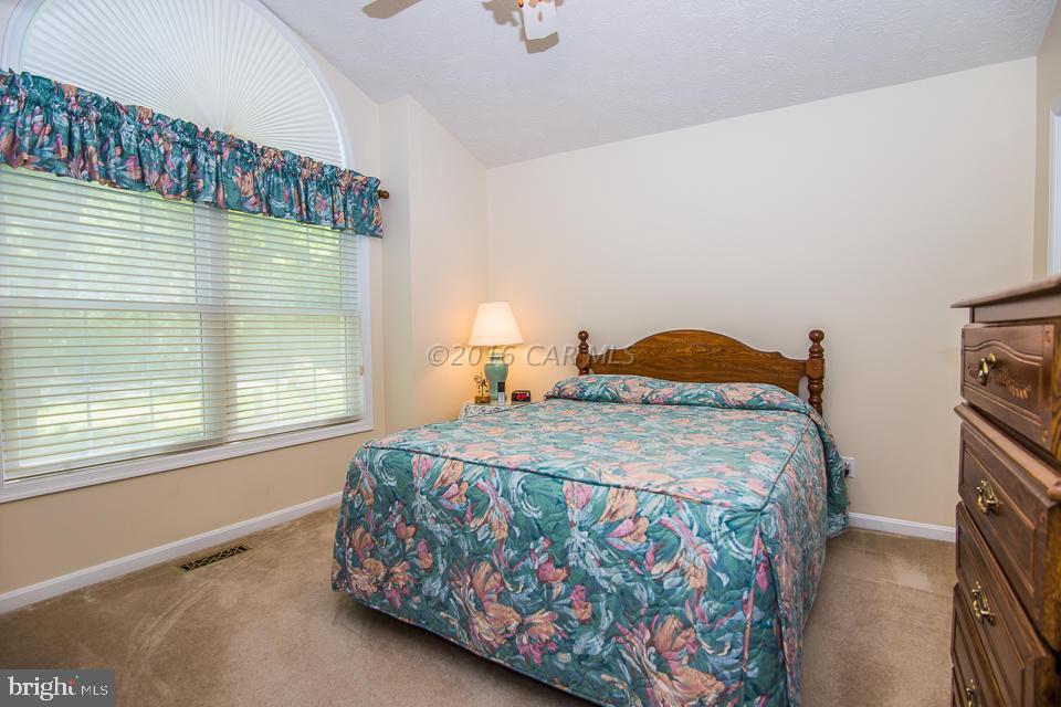 217 Windjammer Road Ocean Pines, MD 21811 - Photo 4 of 47 a bedroom with a bed and a window