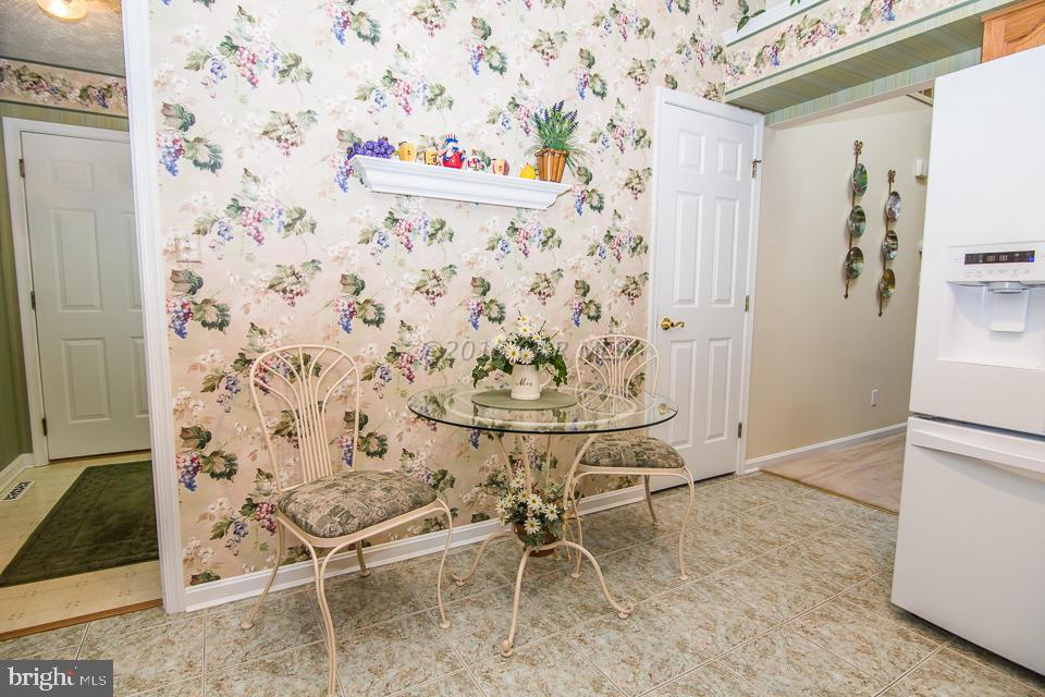 217 Windjammer Road Ocean Pines, MD 21811 - Photo 31 of 47 a dining room with chandelier fan and wooden floor