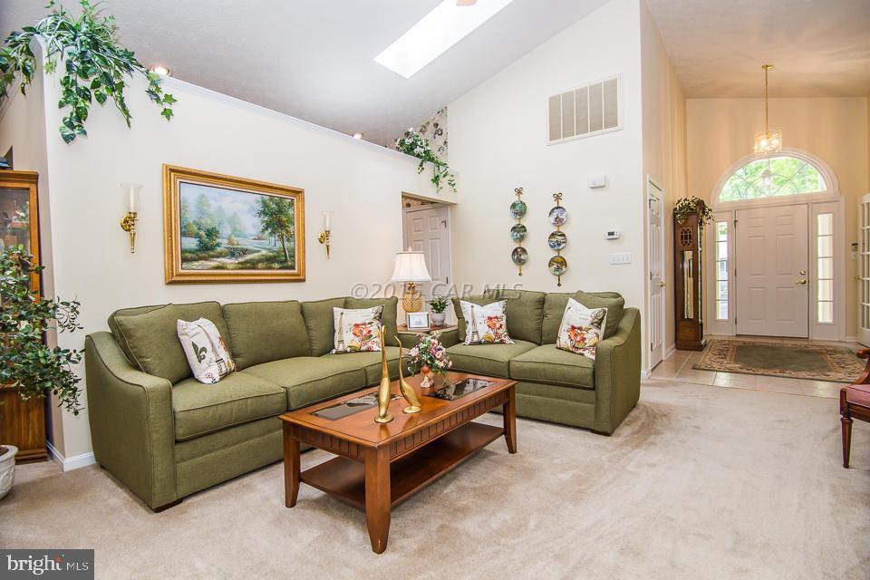 217 Windjammer Road Ocean Pines, MD 21811 - Photo 32 of 47 a living room with furniture and a chandelier