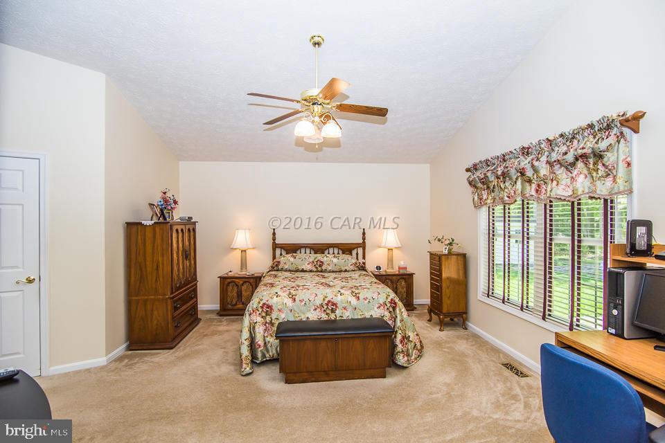 217 Windjammer Road Ocean Pines, MD 21811 - Photo 35 of 47 a bedroom with a bed and a chandelier