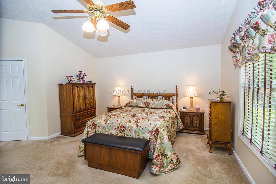 217 Windjammer Road Ocean Pines, MD 21811 - Photo 36 of 47 a bedroom with a bed and a chandelier