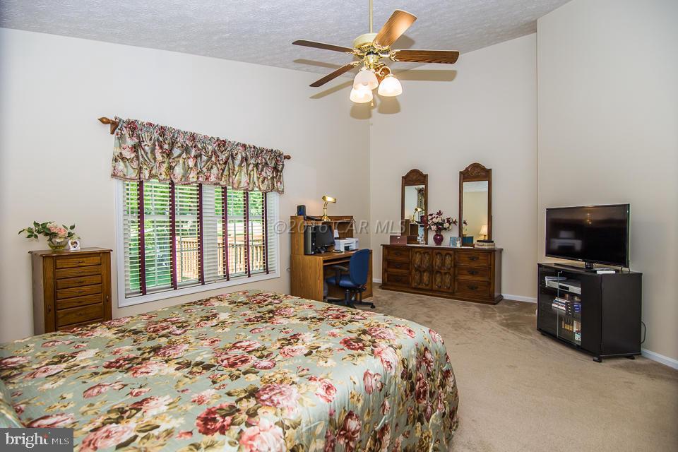 217 Windjammer Road Ocean Pines, MD 21811 - Photo 38 of 47 a bedroom with a bed a dresser and flat screen tv