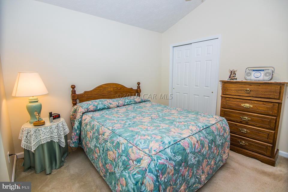 217 Windjammer Road Ocean Pines, MD 21811 - Photo 5 of 47 a bedroom with a bed a table and chair