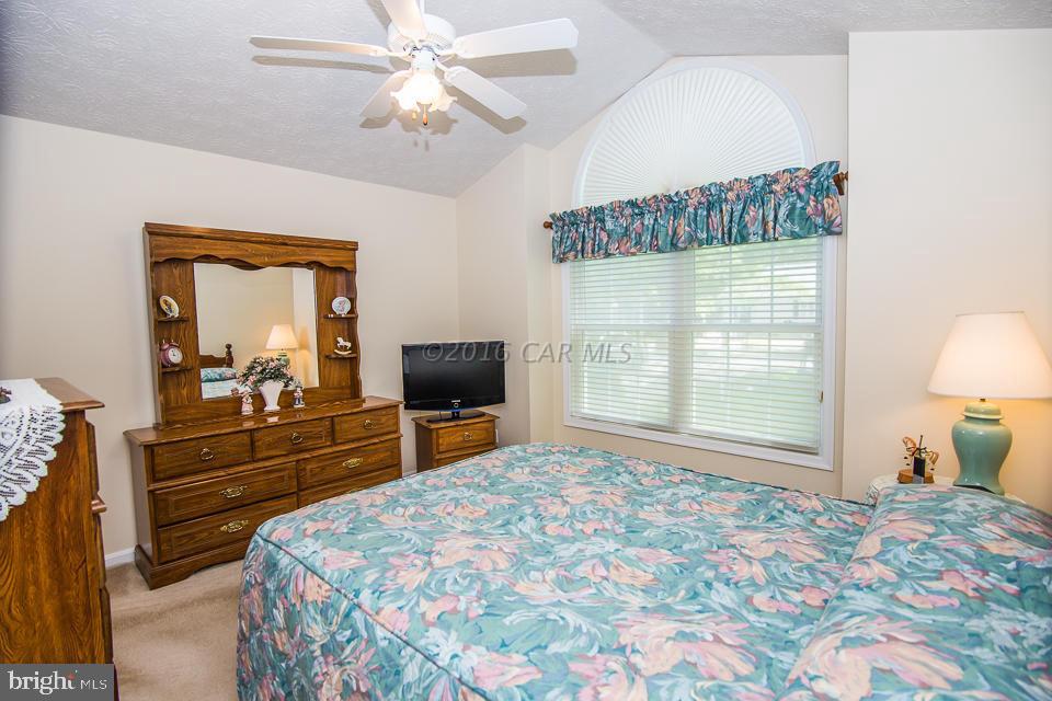 217 Windjammer Road Ocean Pines, MD 21811 - Photo 6 of 47 a bedroom with a bed and a chandelier