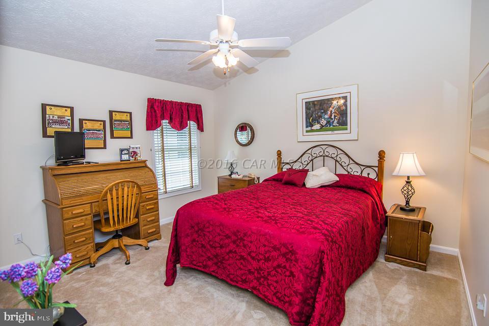 217 Windjammer Road Ocean Pines, MD 21811 - Photo 7 of 47 a bedroom with a bed and a chandelier