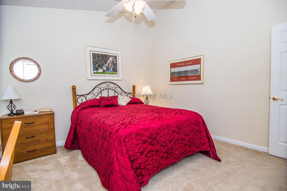 217 Windjammer Road Ocean Pines, MD 21811 - Photo 8 of 47 a bedroom with a bed and a chandelier