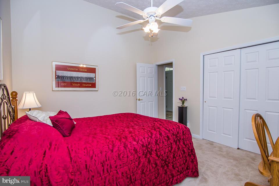 217 Windjammer Road Ocean Pines, MD 21811 - Photo 9 of 47 a bedroom with a bed and a chandelier