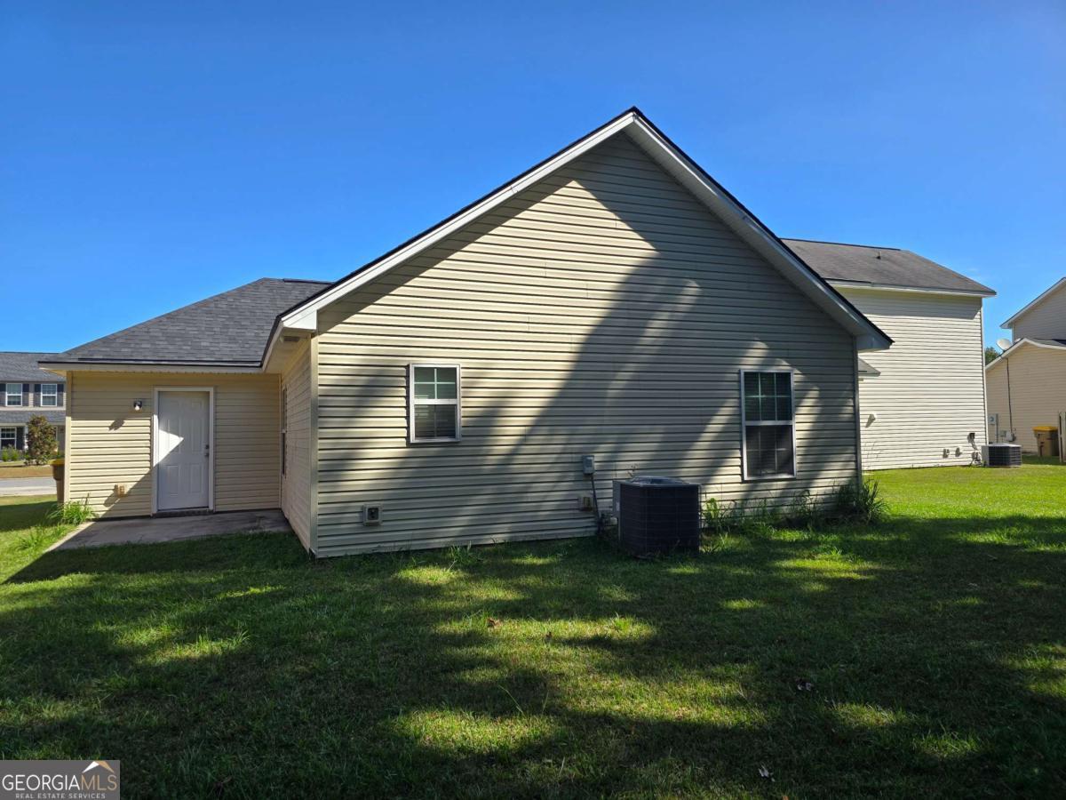 13 Rice Mill Road Port Wentworth, GA 31407 - Photo 17 of 21 a front view of house with yard and green space