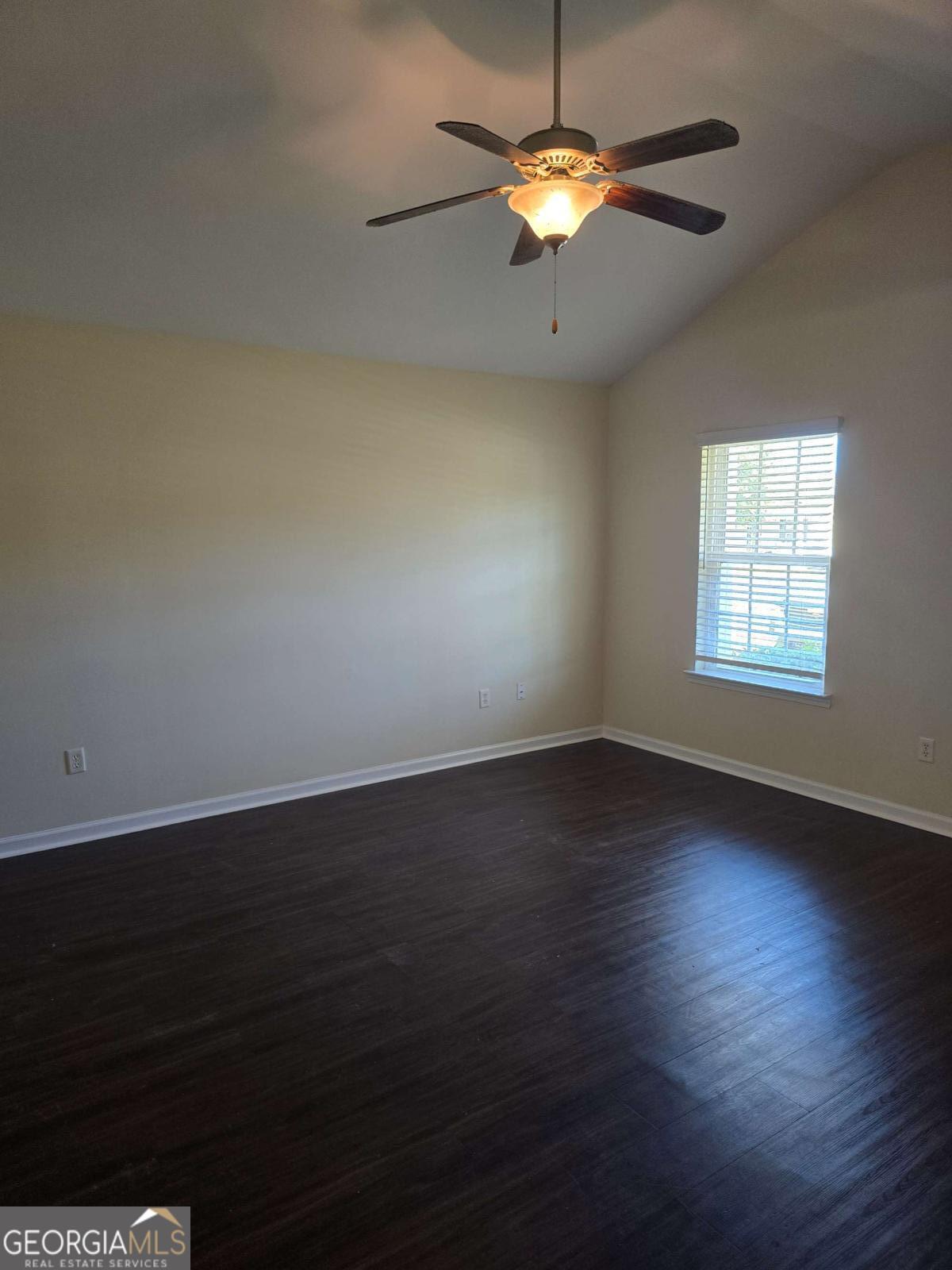 13 Rice Mill Road Port Wentworth, GA 31407 - Photo 3 of 21 an empty room with wooden floor chandelier fan and windows