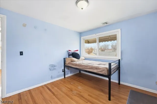 a view of a room with wooden floor and window