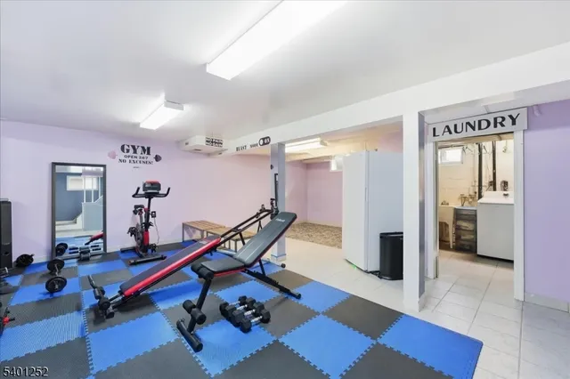 a room with gym equipment and view of living room