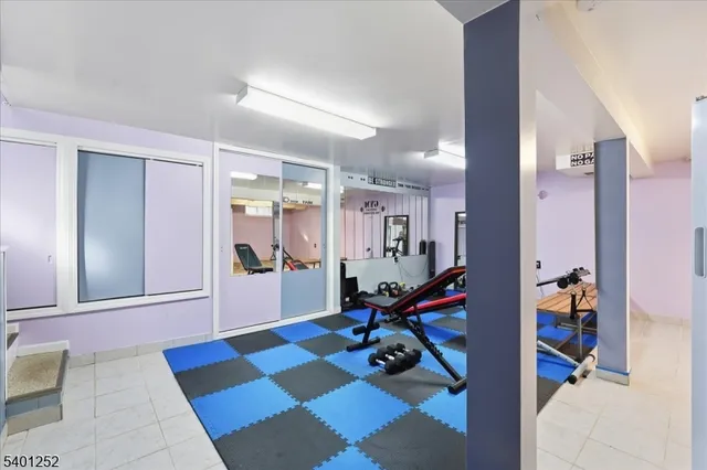 a view of a hallway with workspace and a living room