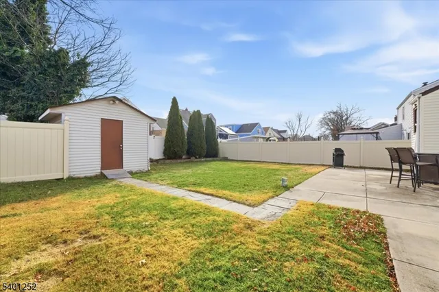 a view of a house with a yard and garage
