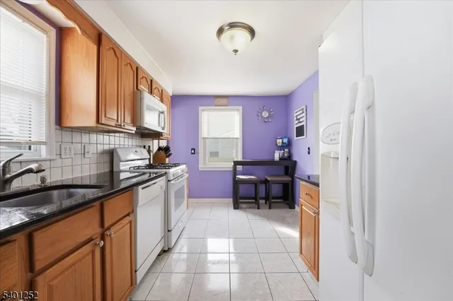 a kitchen with stainless steel appliances granite countertop a sink and cabinets
