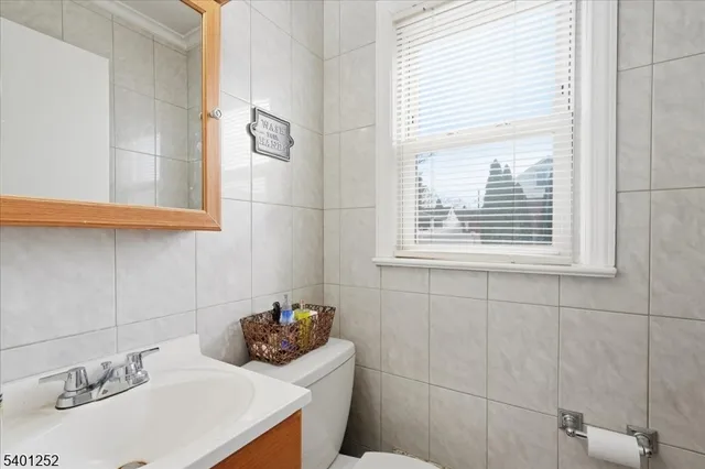 a bathroom with a sink a vanity and a toilet