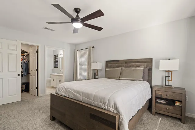 a bedroom with a bed and a chandelier