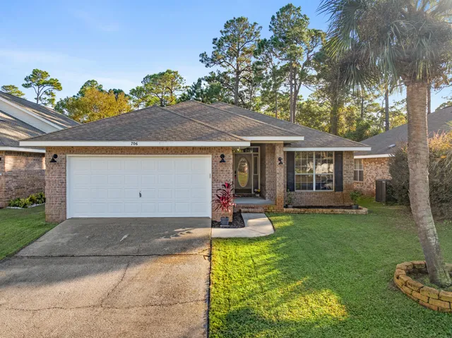 a view of a house with backyard porch and sitting area