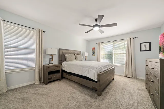 a bedroom with a bed next to a window