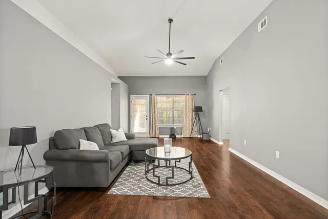 a living room with furniture and a chandelier