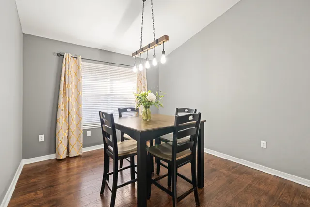 a view of a dining room with furniture and chandelier