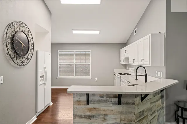 a view of a kitchen area with furniture and wooden floor